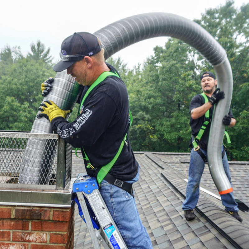 men with a stainless steel chimney liner